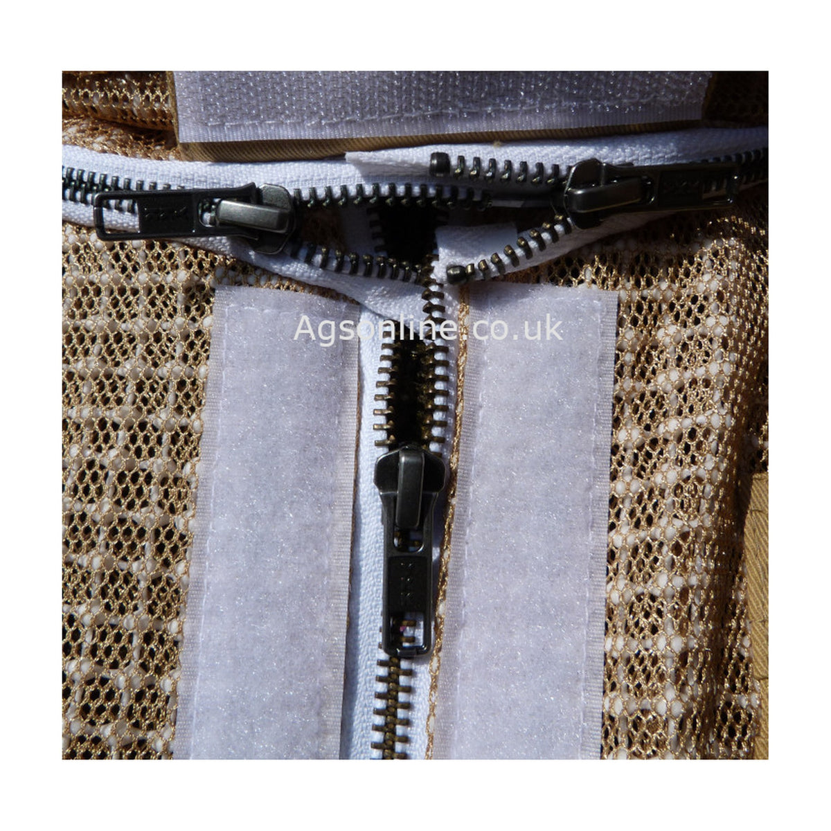 Close-up of metal zips and hook-and-loop flaps on olive 3 layer bee suit