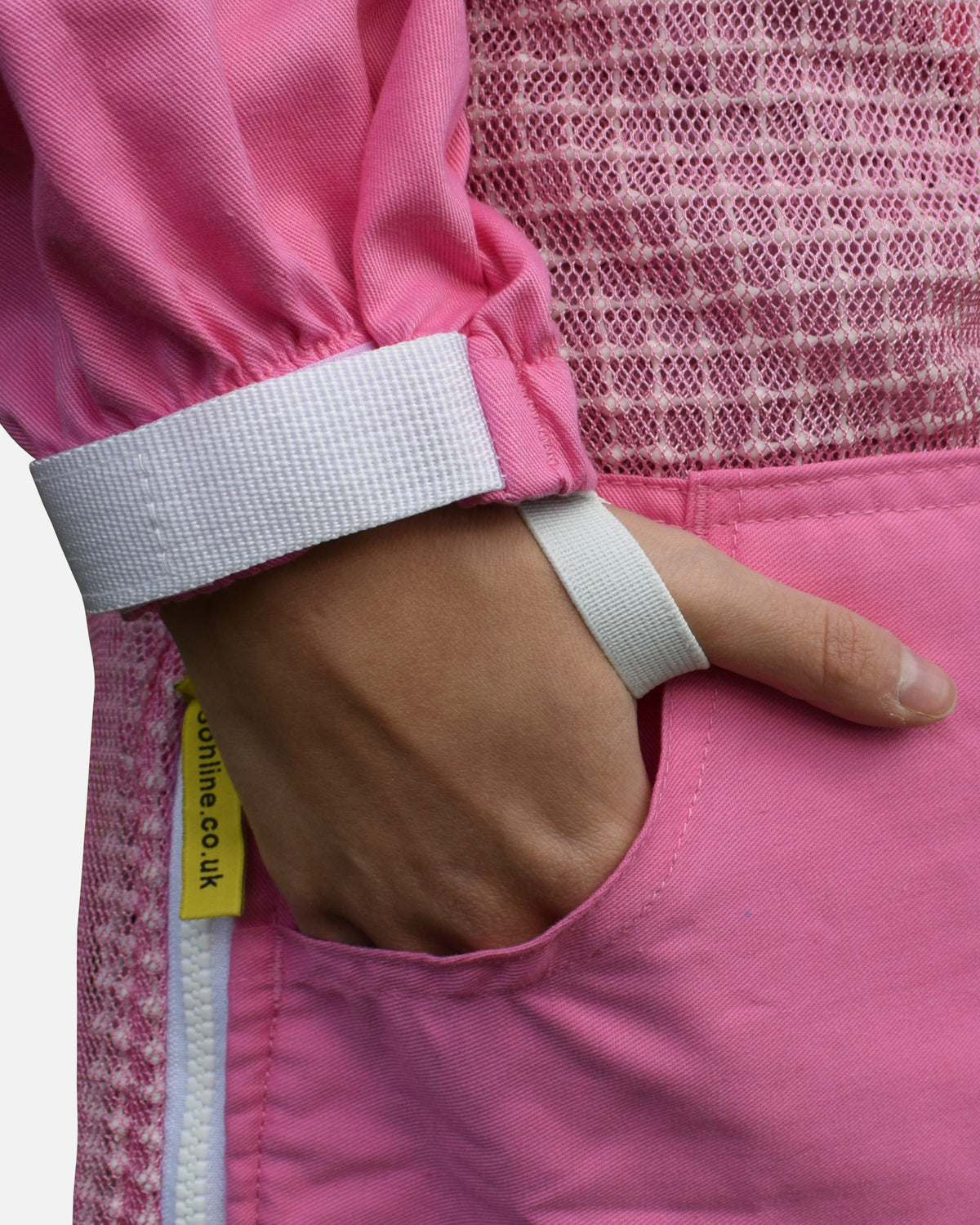 Hand in pocket with thumb loop on pink PRO ventilated beekeeping suit