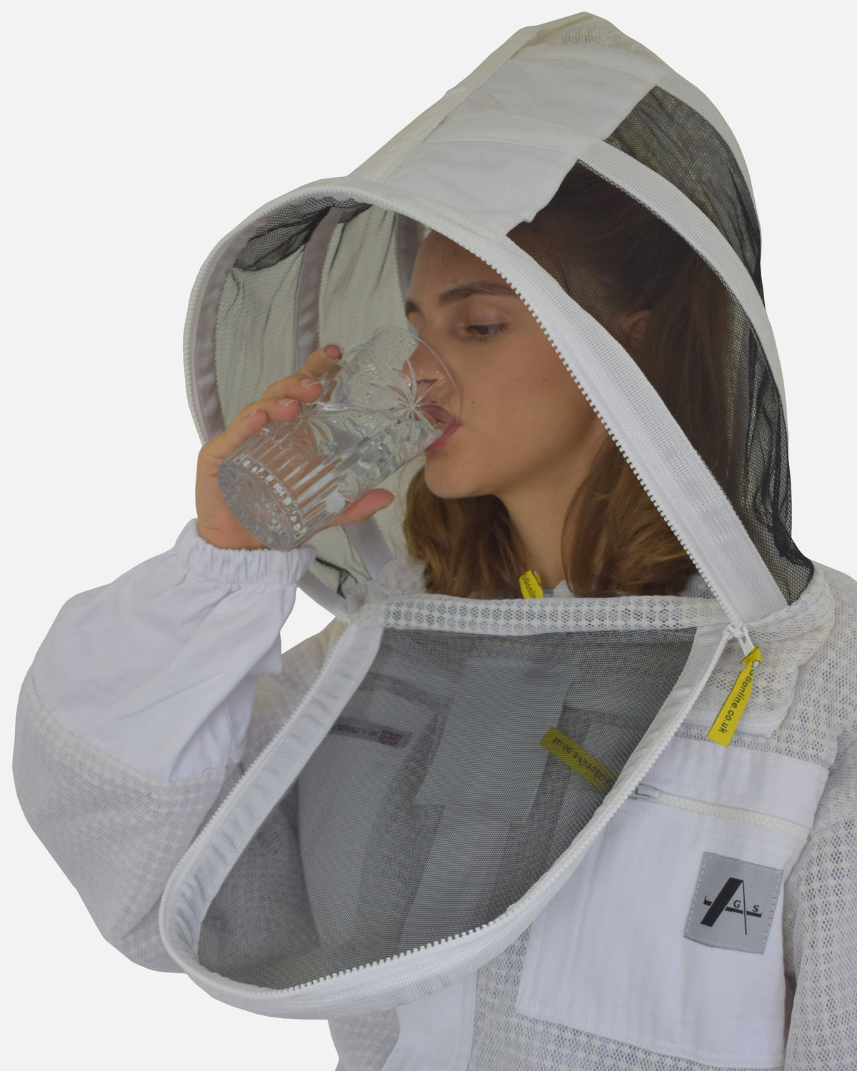 Woman drinking with veil front opened on Blanco PRO ventilado Traje de apicultor